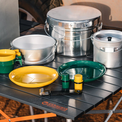 Camping utensils including bowls, plates, and containers on a table with a visible brand logo.